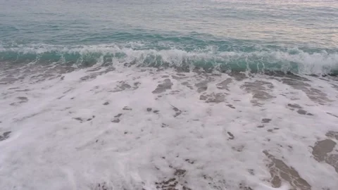 Sea waves on the beach, ocean tides flow on the shore, calm seascape footage. Stock Footage 228676556