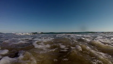 Sea waves on the beach at sunset Stockbeeldmateriaal 80593500