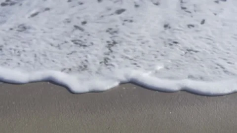 Sea waves on a beach. Of waves arriving on sandy beach. Video stock 130678060