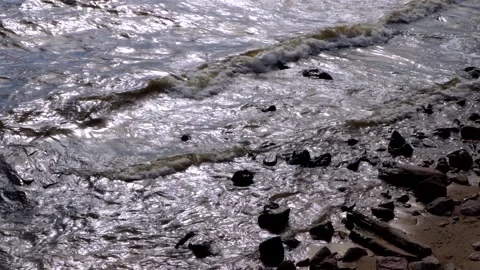 Sea waves beating against the dark rocks on the coastline Stock Footage 214038250