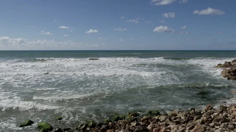 Sea waves break against a stone on the shore Video stock 90366791