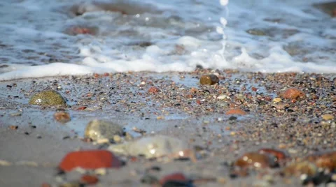 Sea waves break on pebble beach Stock Footage 47139411