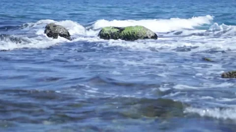 The sea waves break on the rocks. The waters of the sea are raging. Close-up Stock Footage 314978946