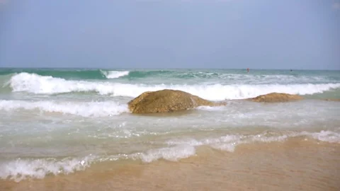 Sea waves break on the stone and run to the sandy shore. slow motion, 1920x1080 Stock Footage 87448731