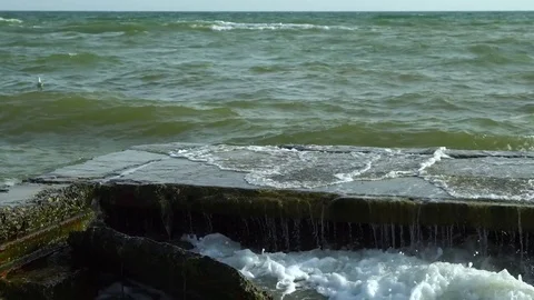 Sea. Waves break on the stone pier. 스톡 동영상 83057842