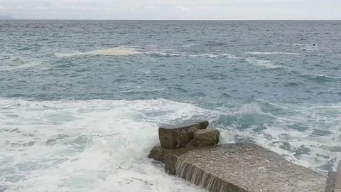 Sea waves break on the stone pier. Slow motion Stock Footage 84130923