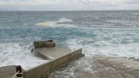 Sea waves break on the stone pier. Slow motion Stock Footage 84131512