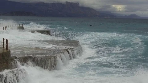 Sea waves break on the stone pier. Slow motion Stock Footage 84132456
