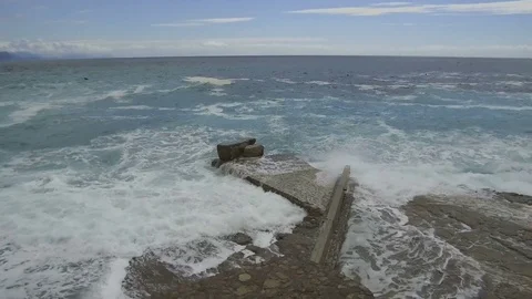 Sea waves break on the stone pier Stock Footage 84229137