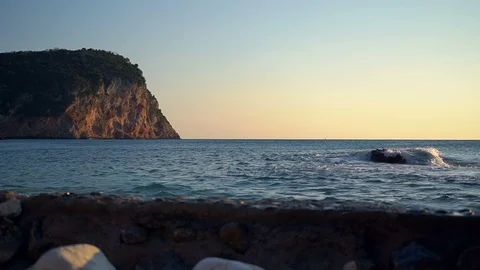 Sea waves break on the stone at sunset. Slow motion Stock Footage 91536084