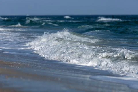 Sea waves breaking into foam Stock Photos