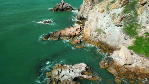 Sea waves breaking over rocks mountains. Vitality of blue energy and clear ocean Stock Footage 249095890
