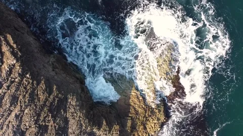 Sea waves breaking over rocks. Stockbeeldmateriaal 277081348