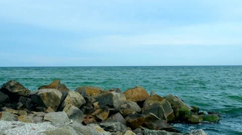 Sea waves breaking over rocky beach Stock-Footage 8765096