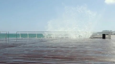 Sea waves breaking on the promenade Stockbeeldmateriaal 76702510