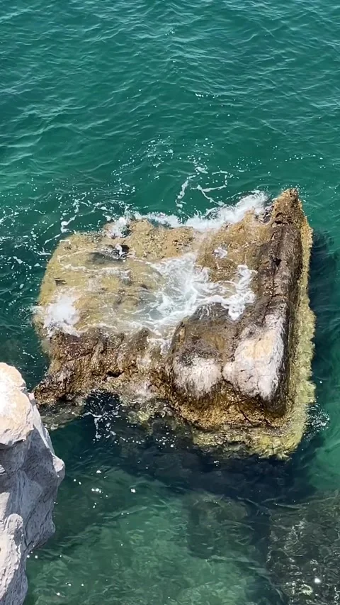Sea waves breaking on a rock in slow motion Stock Footage 276343883