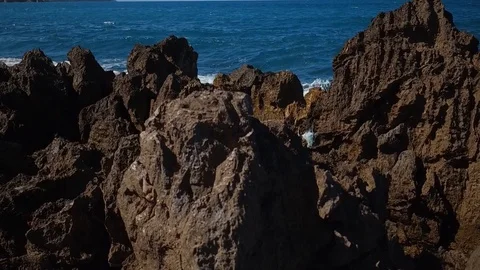 Sea waves breaking rocks Stockbeeldmateriaal 97843373