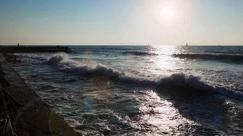 Sea waves breaking on the rocks in the sunset light, slow motion. Stock Footage 96292583