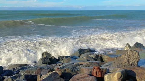 Sea waves breaking wide shot along a rocky shoreline Stock Footage 345361571