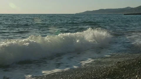 Sea waves closeup with mountains background Stock Footage 130751679