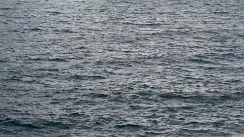 Sea waves on cloudy day. Light reflection on water surface. Disturbed Stock Footage 260413949