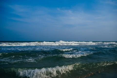 Sea with waves on a cloudy day Stock Photos