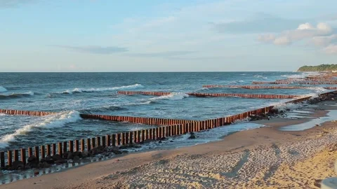 Sea waves on the coast with wave breakers Video stock 140134315