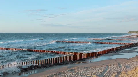 Sea waves on the coast with wave breakers, blue sky Stock Footage 140134324