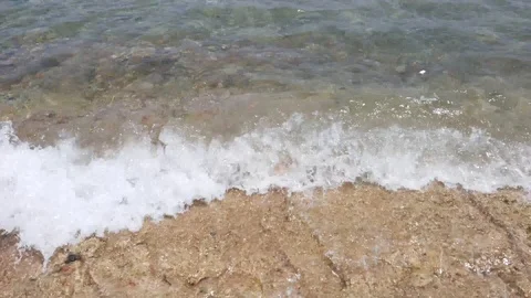 Sea waves crash on the beach. Waves and white sea foam closeup Stock Footage 117963525