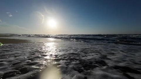 Sea waves crash into the camera. Green plastic container thrown into the sea Stock Footage 276711408