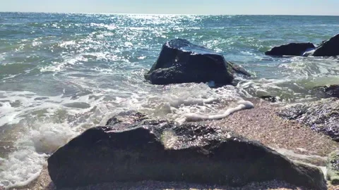 Sea waves crash on large rocks on the shore Stock Footage 160337159