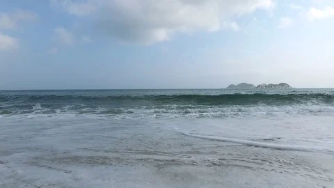 Sea waves crash over the sand beach on unny day Stock Footage 100899896