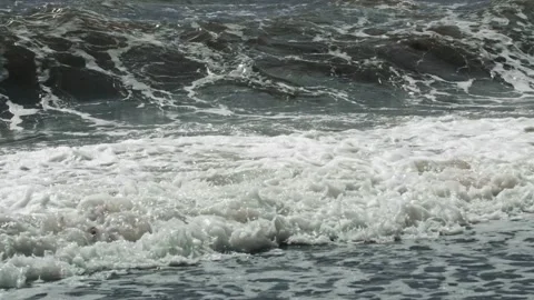 Sea waves crash with a splash against the coastal bottom in slow motion. A long Stock Footage 220997489