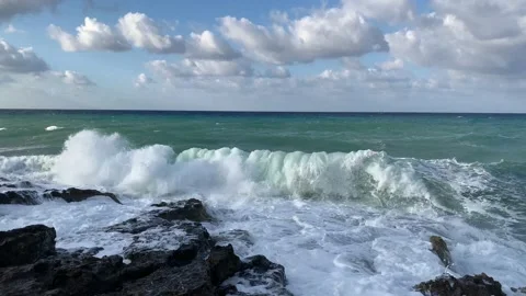Sea waves crashed into the rocks on the shore. Stock Footage 163063898