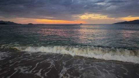 Sea Waves Crashing On Sandy Beach At Sunrise With Mountains Background Stock-Footage 345185313