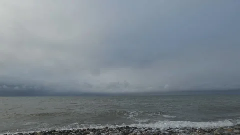 Sea waves crushing on the pebble beach on a cloudy day. Stock Footage 265627546