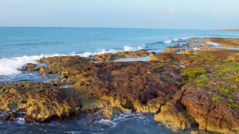 Sea ​​waves eroding the rocks on the beach Stock-Footage 244774266