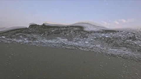 Sea waves filmed from the water surface at sunset with split underwater and.. 스톡 동영상 342586961