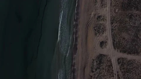 Sea waves flowing ashore in windy weather, shooting from the height of the drone Stock Footage 154559993