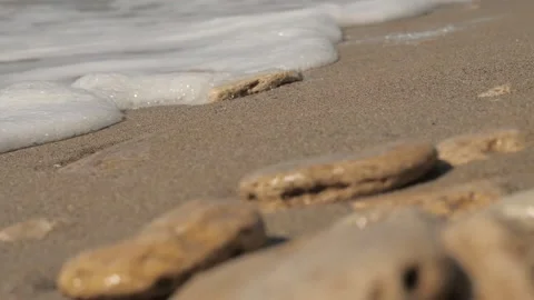 Sea ??waves with foam on a sandy beach with stones. sea stones Stock Footage 132908353
