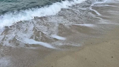 Sea waves with foam on sandy beach Stock Footage 256083350