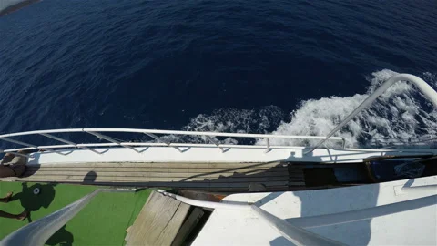 Sea waves form foam under the side of a ship Stock Footage 127744457