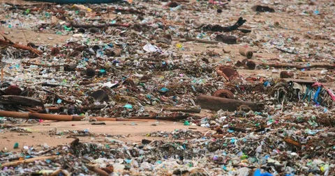 Sea waves full of litter hitting the beach. Huge dump in tropical paradise. M Stock Footage 127369889