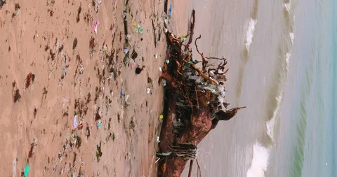 Sea waves full of litter hitting the beach. Huge dump in tropical paradise. M Video stock 127385363