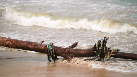 Sea waves full of litter hitting the beach. Huge dump in tropical paradise. M Video stock 127386711