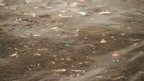 Sea waves full of litter hitting the beach. Huge dump in tropical paradise. M Video stock 127388506