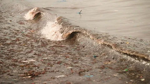 Sea waves full of litter hitting the beach. Huge dump in tropical paradise. M Video stock 127390015
