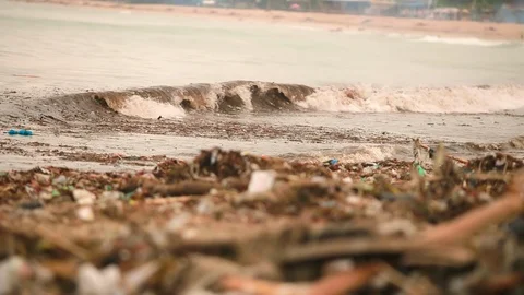 Sea waves full of litter hitting the beach. Huge dump in tropical paradise. M Stock Footage 127393194