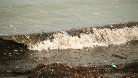 Sea waves full of litter hitting the beach. Huge dump in tropical paradise. M Stock Footage 127394170