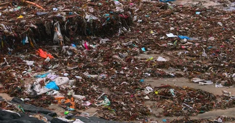 Sea waves full of litter hitting the beach. Huge dump in tropical paradise. M Stock Footage 127438799